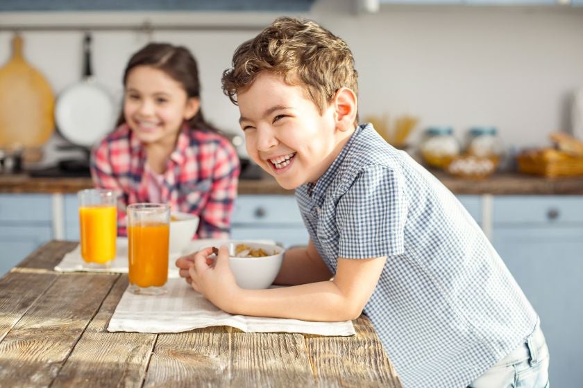 Two children smiling in kitchen
